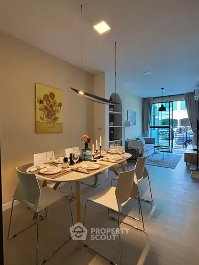 Modern dining area with elegant table setting and cozy living room view
