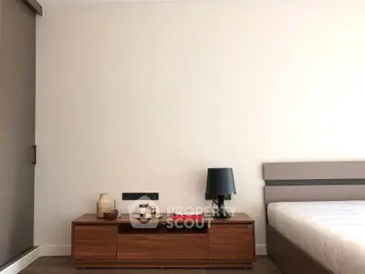 Modern bedroom with sleek wooden furniture and minimalist decor