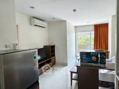 Spacious living room with modern appliances and balcony view