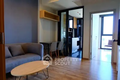 Modern living room with cozy sofa and wooden flooring in a stylish apartment.