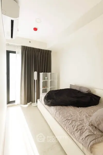 Modern minimalist bedroom with natural light and sleek furnishings