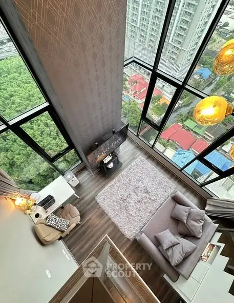 Stunning high-rise living room with floor-to-ceiling windows and breathtaking city view.