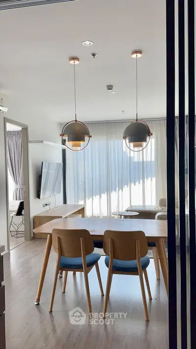 Modern living room with stylish dining area and large windows