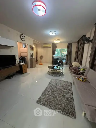 Spacious living room with modern decor and large windows for natural light.