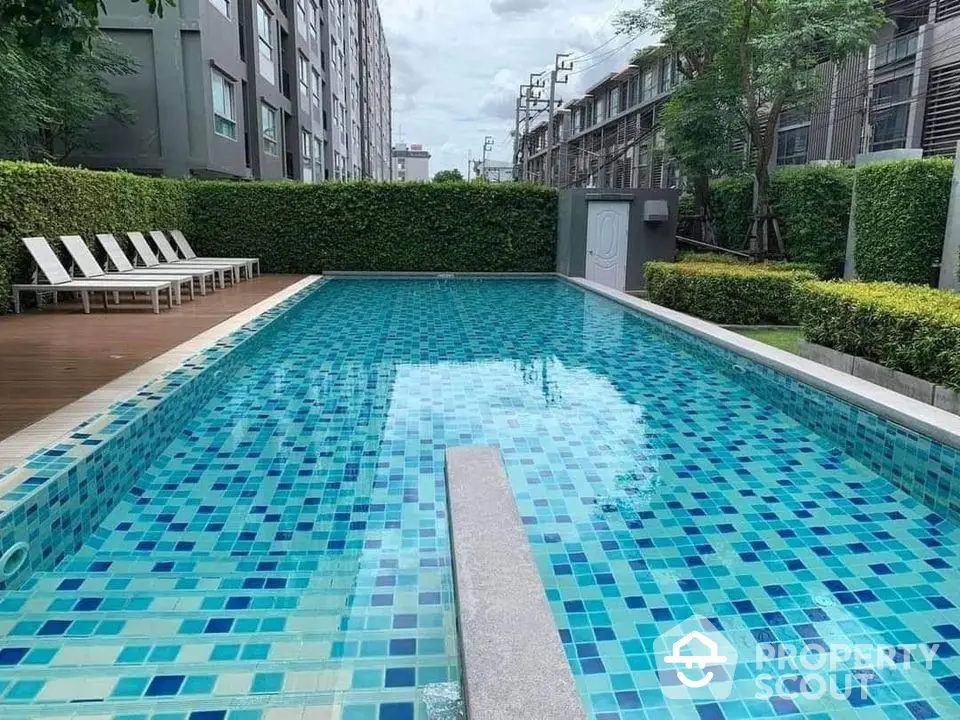 Stunning outdoor swimming pool with modern design in a residential complex.