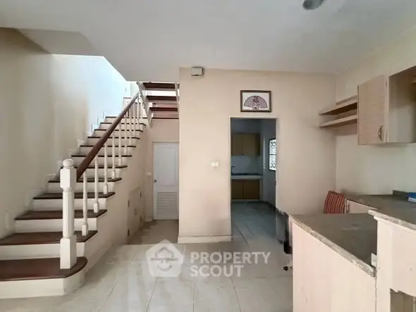 Spacious interior with staircase and open kitchen layout in modern home