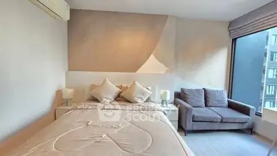 Modern bedroom with cozy bed and stylish sofa in a bright apartment