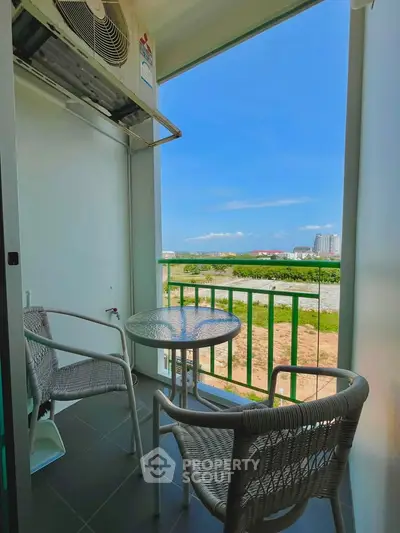 Charming balcony with seating and scenic view, perfect for relaxation and enjoying the outdoors.