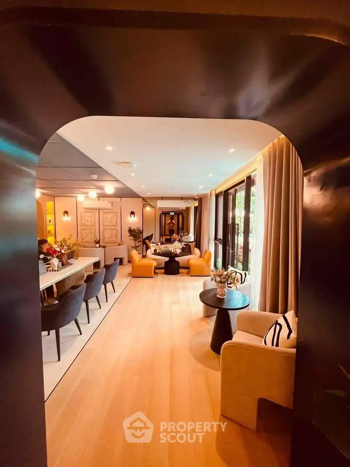 Luxurious open-plan living room with elegant decor and large windows for natural light.