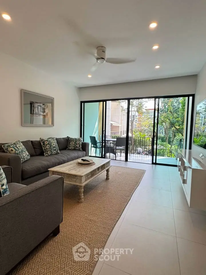 Stylish living room with modern decor and balcony view, perfect for relaxation and entertaining.