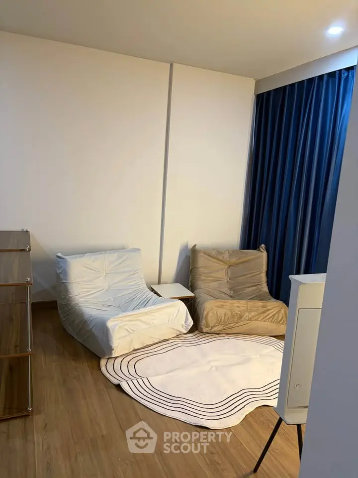 Cozy living room with modern chairs and stylish rug, perfect for relaxation.