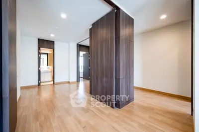 Spacious modern living room with wooden flooring and large windows