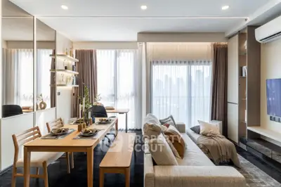 Modern open-plan living and dining area with stylish decor and city view.