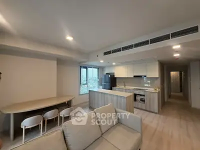 Modern open-layout living room and kitchen with sleek design and natural light