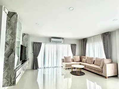 Spacious modern living room with elegant marble accents and plush seating