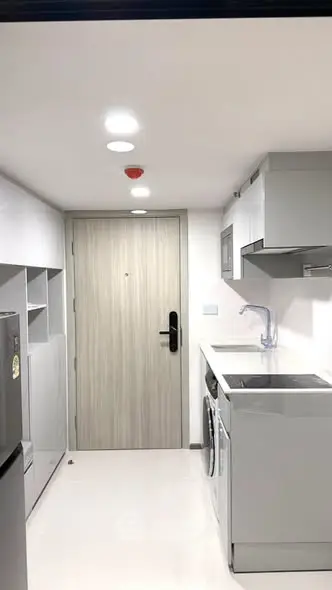 Modern compact kitchen with sleek appliances and minimalist design