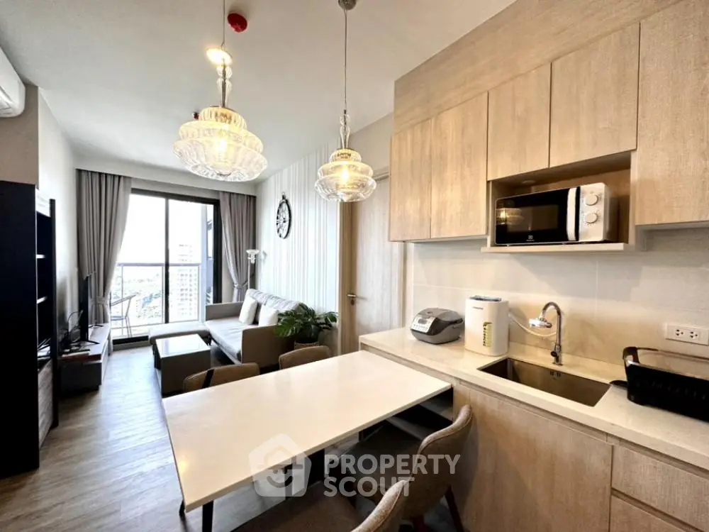 Modern open-layout living room and kitchen with elegant lighting and city view.
