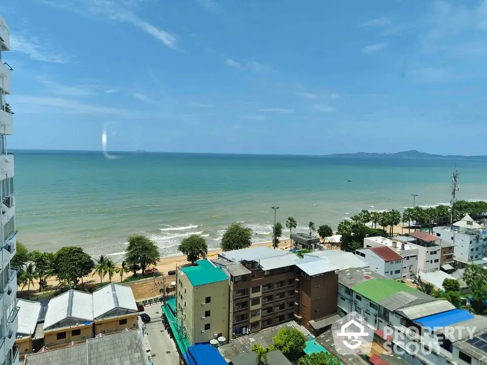 Stunning ocean view from high-rise building overlooking beach and cityscape.