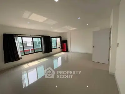 Spacious empty room with large windows and glossy tiled floor, perfect for customization.