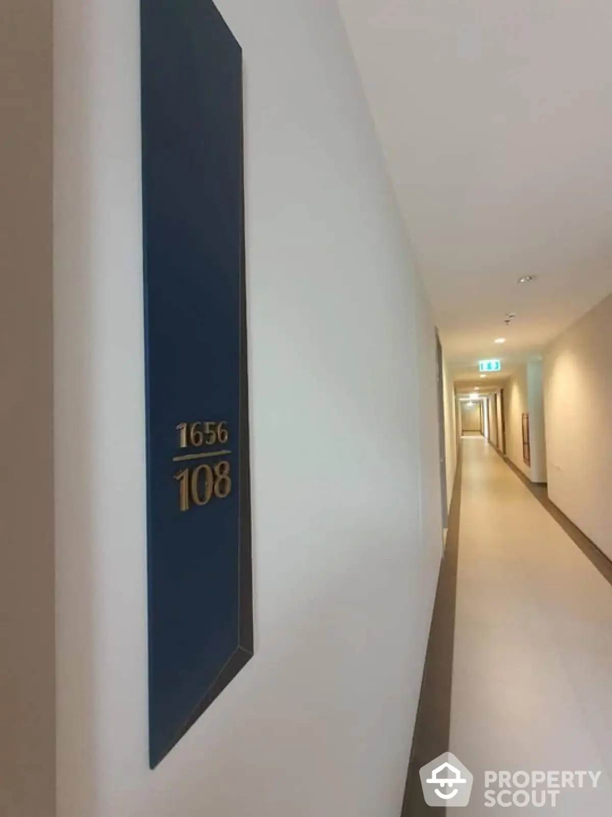 Modern apartment hallway with room number signage and sleek design