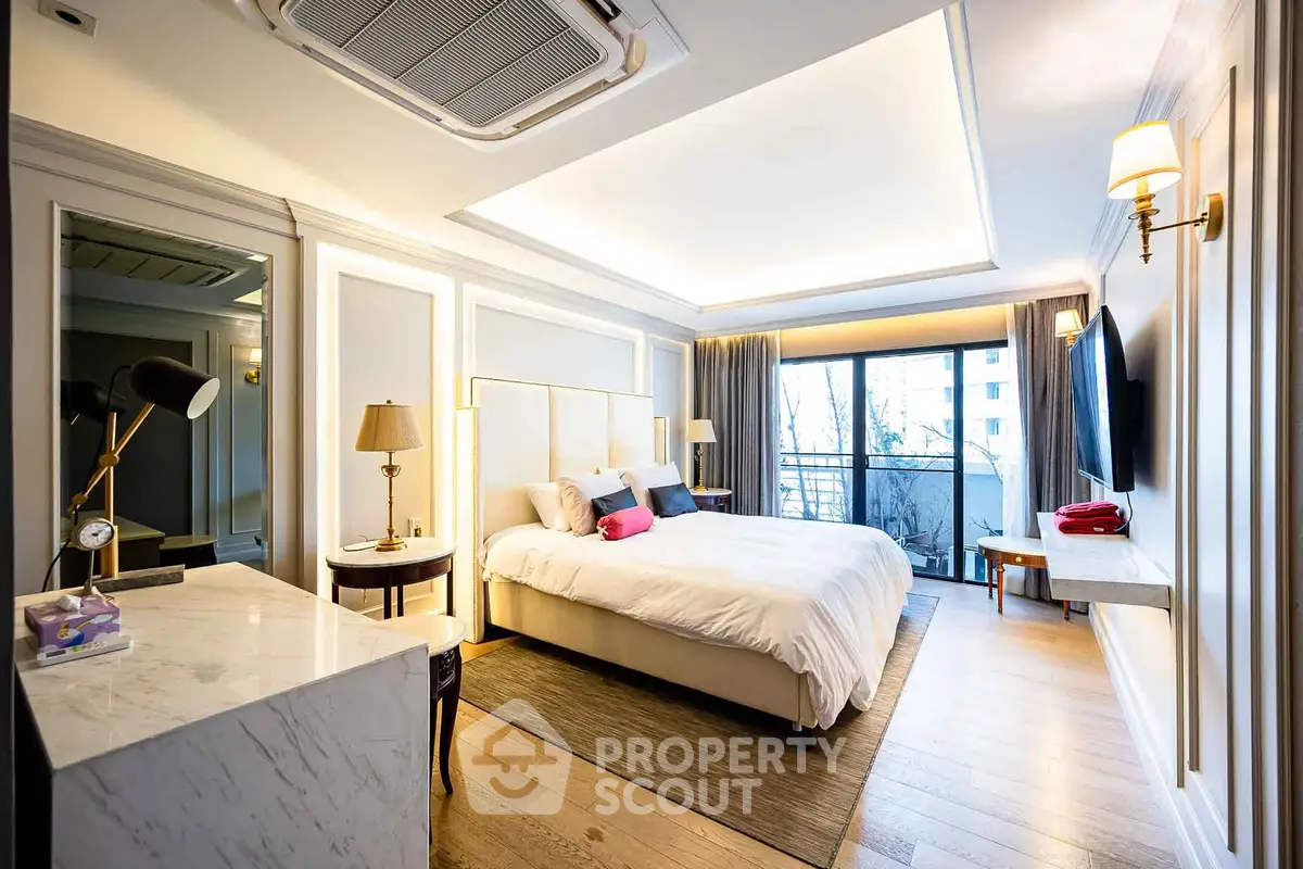 Luxurious bedroom with modern decor and large window offering natural light.
