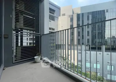 Modern apartment balcony with city view and sleek railing design.