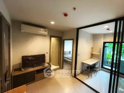 Modern apartment interior with living room, bedroom, and study area, featuring sleek design and natural light.