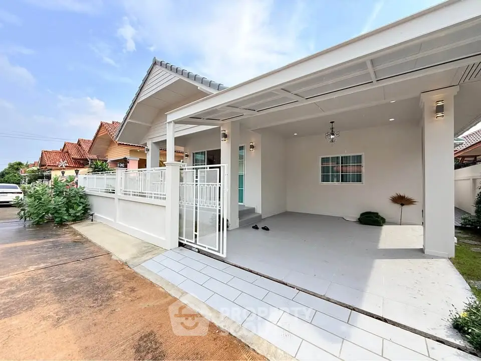Charming single-story home with spacious driveway and modern exterior design.