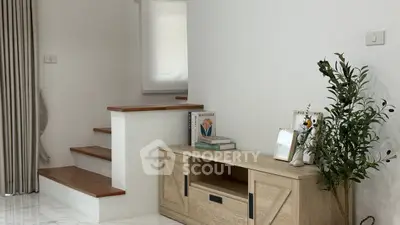 Charming interior with wooden staircase and stylish decor in a cozy living space.