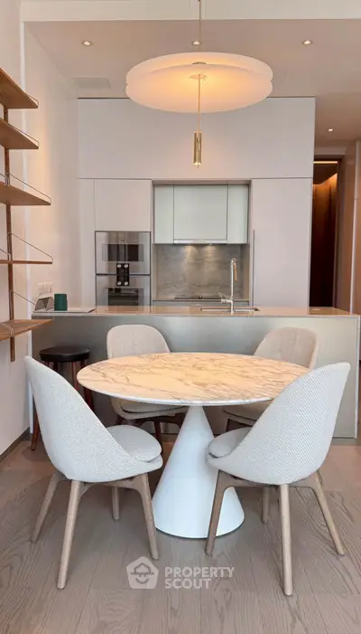 Modern kitchen with elegant dining area and stylish lighting