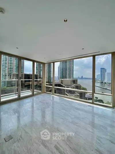 Luxurious high-rise apartment with stunning river view and floor-to-ceiling windows.
