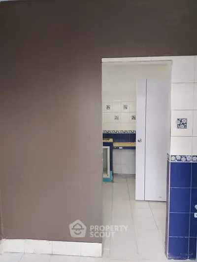 Charming kitchen with blue and white tile accents and modern cabinetry.