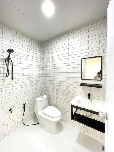 Modern bathroom with white subway tiles and sleek fixtures