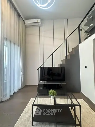 Modern living room with high ceilings and stylish staircase