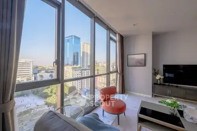 Stunning high-rise living room with panoramic city views and modern decor.