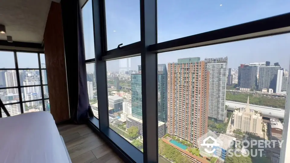 Stunning city view from high-rise apartment with floor-to-ceiling windows