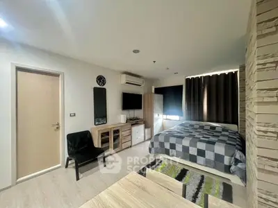 Modern bedroom with stylish decor and natural light, featuring a cozy bed and sleek furniture.