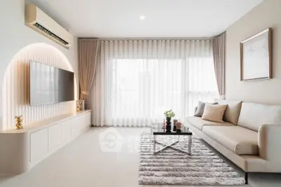 Modern living room with sleek design, featuring a wall-mounted TV, elegant sofa, and large window with sheer curtains.