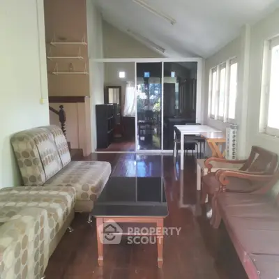 Spacious living room with modern furniture and large windows for natural light.