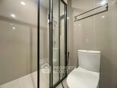 Modern bathroom with glass shower enclosure and sleek toilet design