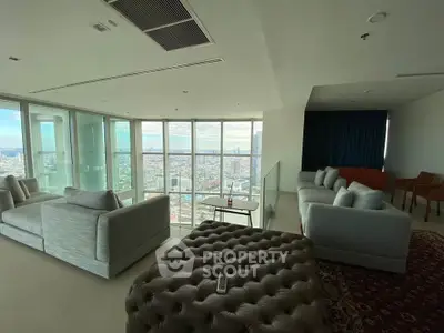 Luxurious high-rise living room with panoramic city views and elegant furnishings.
