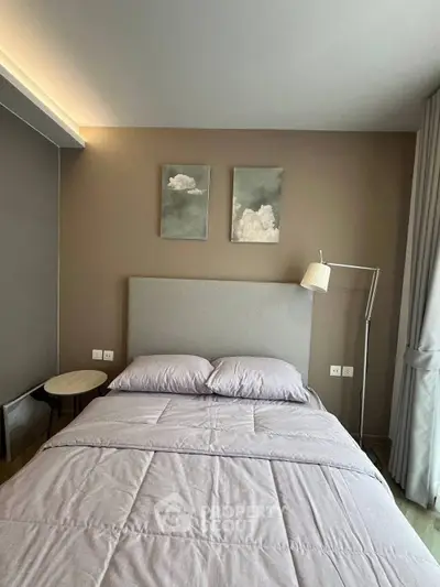 Cozy bedroom with modern decor and soft lighting, perfect for relaxation.