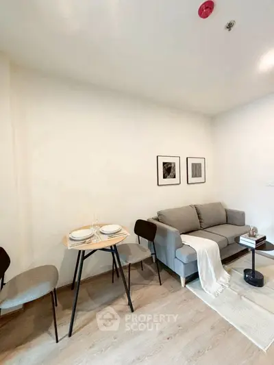 Modern living room with cozy sofa and dining area in stylish apartment.