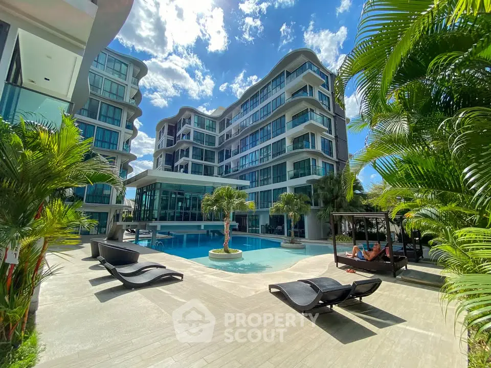 Luxurious modern apartment complex with stunning pool and lush greenery