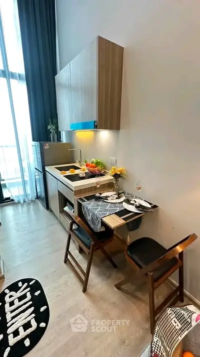 Modern compact kitchen with dining area in stylish apartment