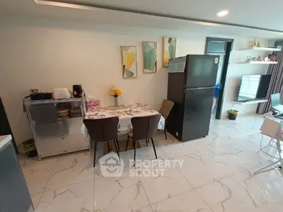 Modern kitchen with dining area, sleek appliances, and stylish decor