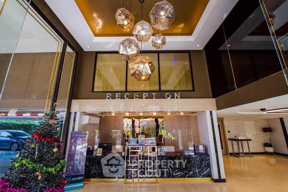 Luxurious hotel reception area with modern decor and festive Christmas tree.