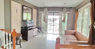 Spacious living room with modern decor and large windows for natural light.