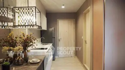 Modern kitchen with sleek design and elegant lighting in a cozy apartment.