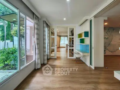 Spacious modern living area with large windows and stylish decor